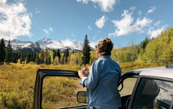 Person outside car on mountain